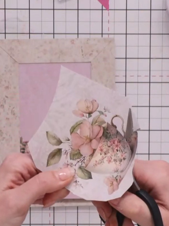 Step 3: Fussy cut a teacup element from the paper collection using scissors. Carefully cut around the detailed areas o