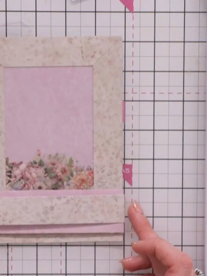 Step 5: Cut a third panel from the floral patterned paper measuring half an inch (approximately 1.3 cm) in height. Pos