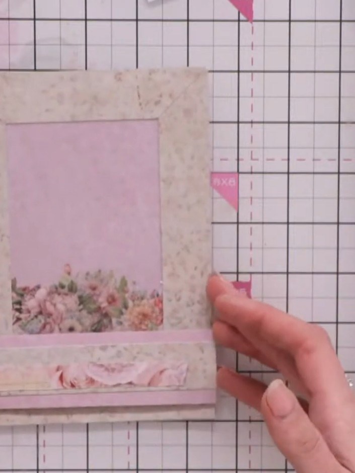 Step 7: Add a decorative element, such as a bird cage embellishment, to the top corner of the frame to balance the com