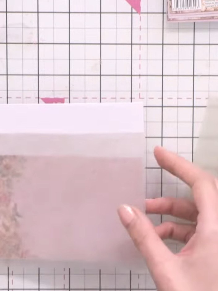 Step 2: Select a light-coloured vellum sheet and trim it to size. Layer the vellum diagonally across the bottom sectio