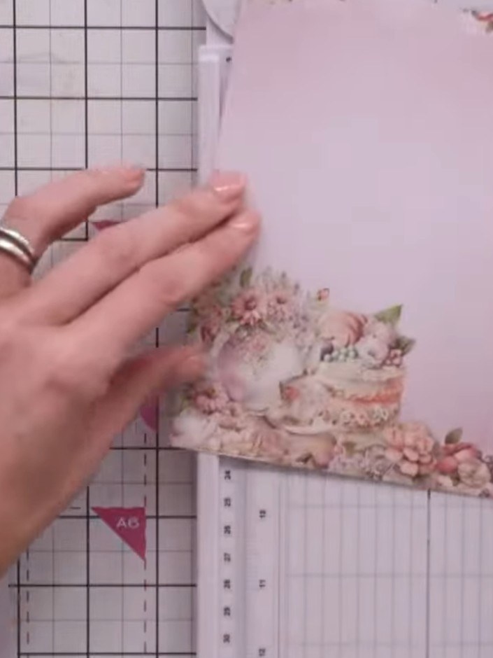 Step 3: Using a craft knife and ruler, carefully cut a window aperture in the pink card, following the floral design a