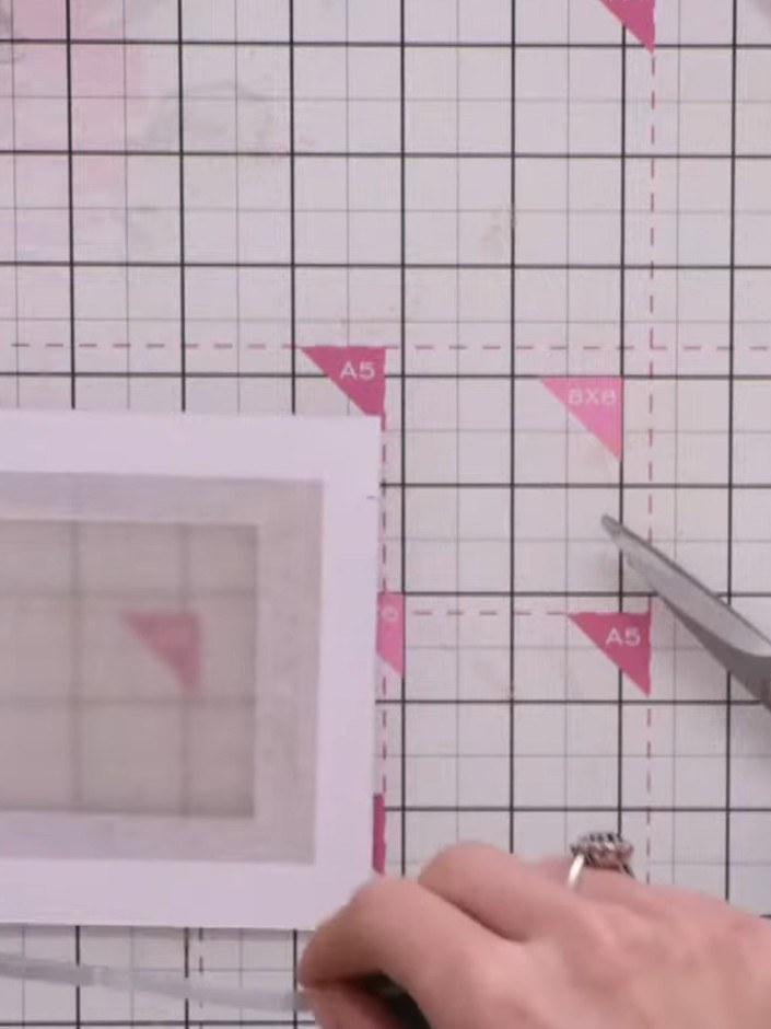 Step 7: Place a thin piece of white paper inside the shaker frame to act as a backing, preventing the embellishments f