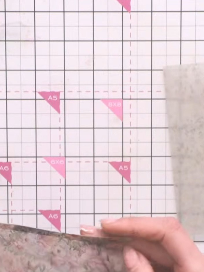 Step 11: Attach the vellum backing piece to the scored vellum envelope using the tape pen. Apply the adhesive along the