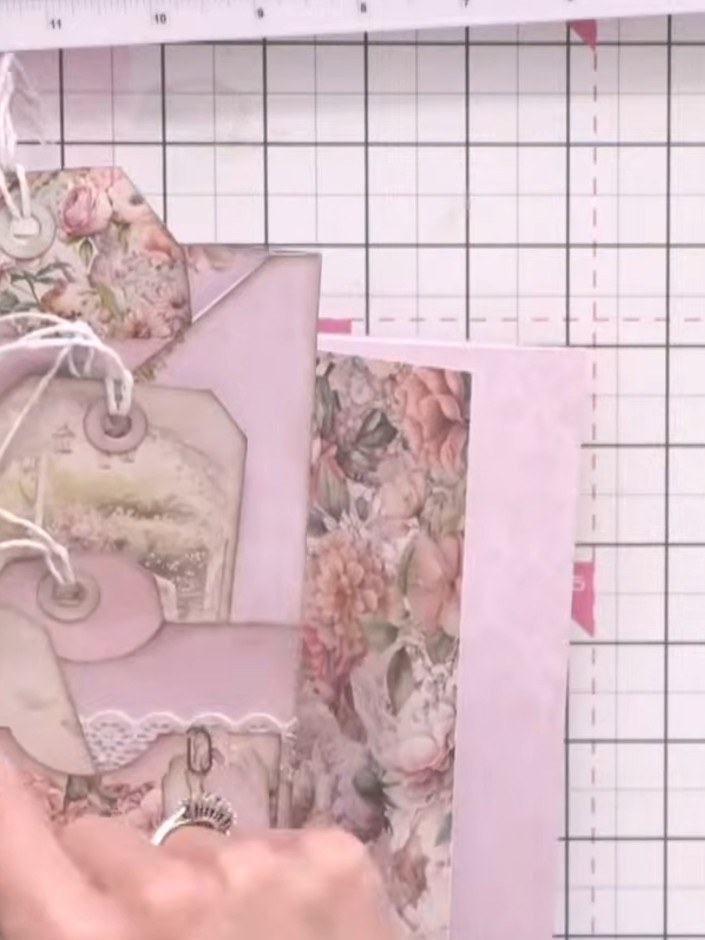 Step 4: Arrange the floral patterned panels and plain pink panels in a stacked formation, creating layered pockets at 