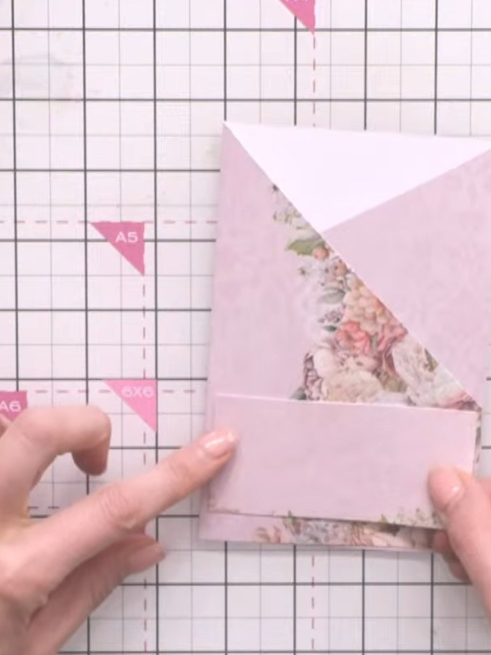 Step 6: Use a tape pen to apply adhesive to the back of the decorative floral paper strips. Position and press them in
