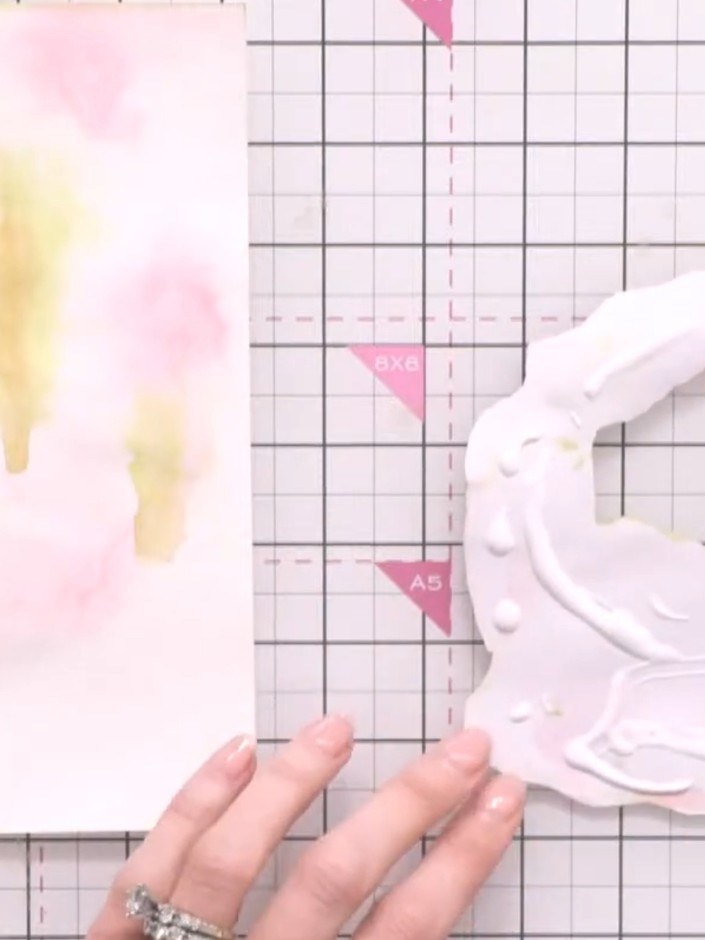 Step 10: Apply adhesive thoroughly to the back of the painted watercolour topper, ensuring complete coverage across all