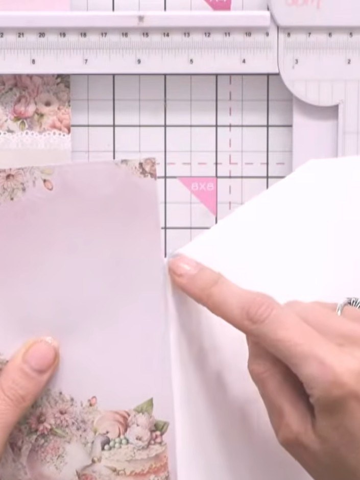 Step 6: Cut a second piece of decorative paper slightly smaller than the first. Mark a point along the top edge where 