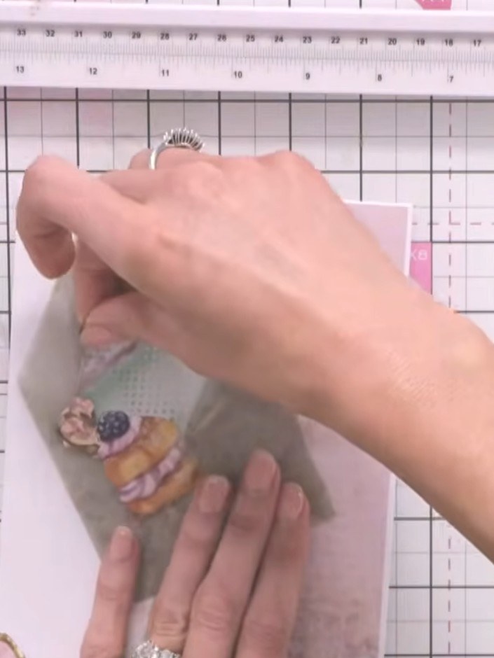 Step 11: Add foam pads to the back of one of the decorative embellishments to create dimension on your card.