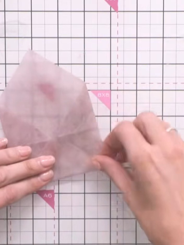 Step 4: Score the folds firmly with your finger to create crisp edges on the vellum envelope.