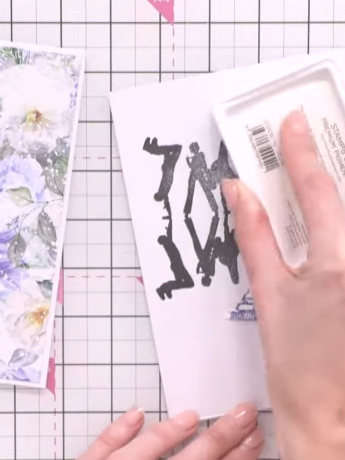 Step 8: Apply white ink around the edges of the stamped Eiffel Tower and silhouette elements using an ink pad. Gently 