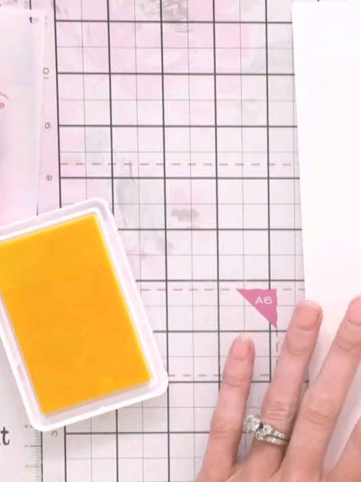 Step 4: Apply orange ink to the stencilled area, blending it with the yellow to create a warm colour transition across
