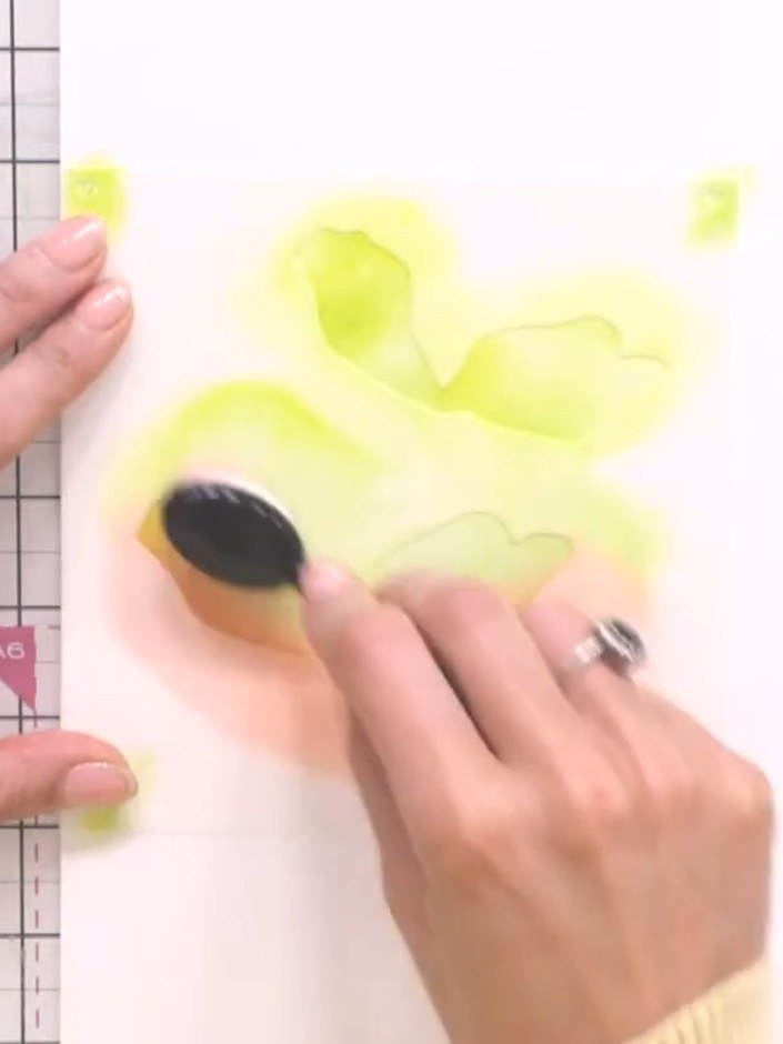 Step 5: Place stencil number three over your previous watercolour work. Using a blending tool with black ink, add tran