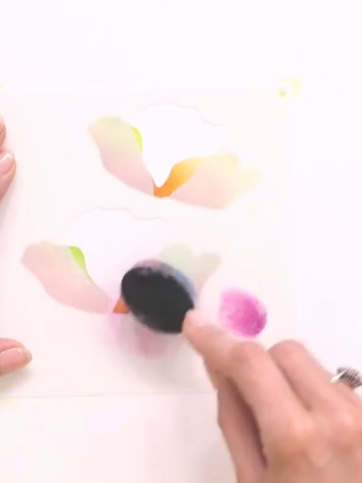 Step 7: Position the leaf stencil on your background and apply teal-coloured ink using a blending tool.
