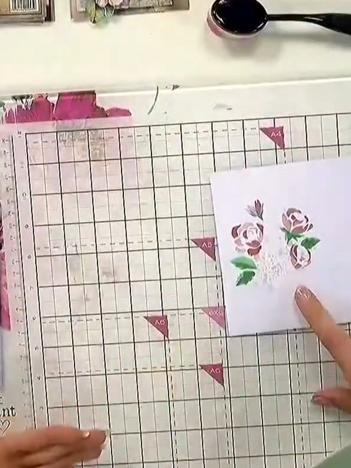 Step 6: Allow the ink to dry completely between layers. The floral design with pink roses and green leaves should be f