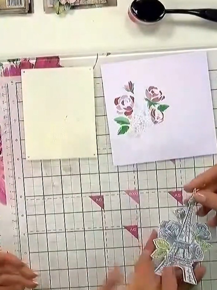 Step 3: Stamp the Eiffel Tower design onto your stencilled background using the clear stamp, pressing down firmly and 