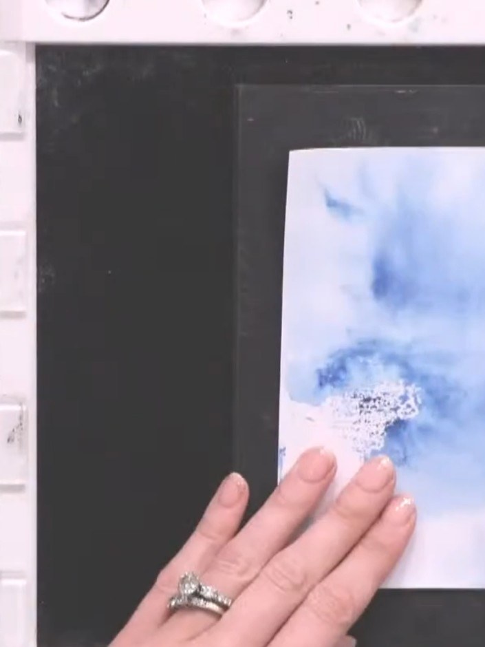 Step 4: Stamp the mason jar image and flower stems onto the dried watercolour background using black ink. Position the