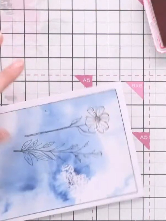 Step 4: Spray pink ink onto a craft mat with water. Use a brush to pick up the diluted pink ink and colour the flower 