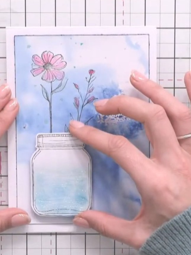 Step 6: Colour the stamped flowers with watercolour, adding pink to the petals to tie in with the design. Build up the