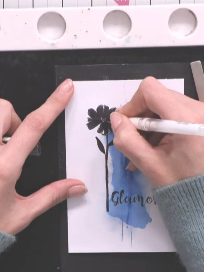Step 3: Stamp a chunky sentiment phrase onto the white card panel using black ink. Position the sentiment below the bl