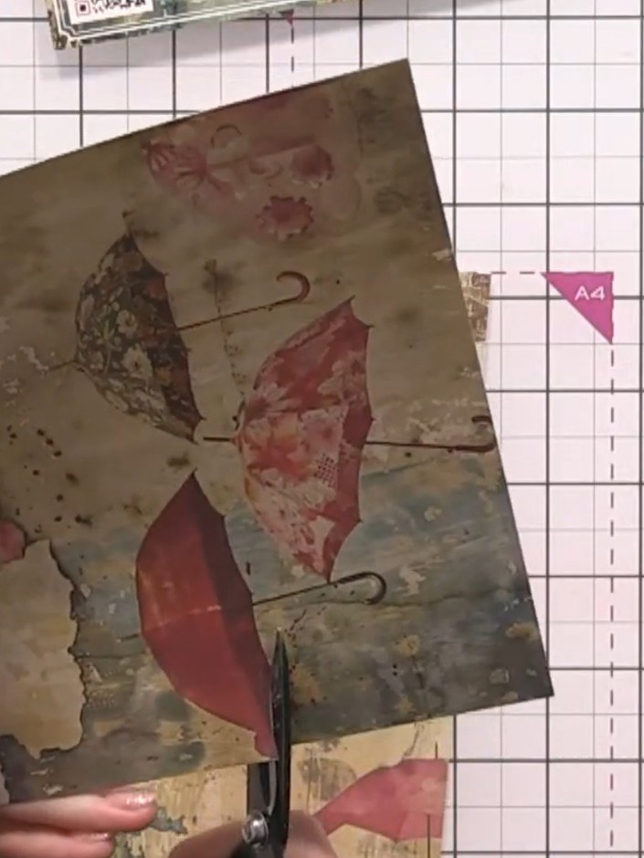 Step 7: Fussy-cut the umbrella shapes from the patterned paper, cutting around the umbrella canopies but leaving off t