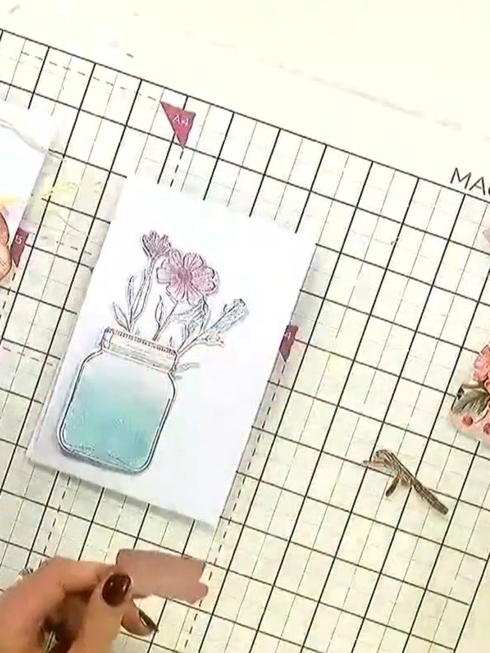 Step 6: Apply foam pads to the back of the die-cut flowers. Position the flowers on the card, placing them around the 