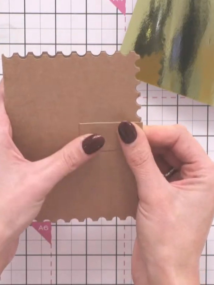 Step 5: Secure the closure strip to the back of the card with glue, positioning it so it wraps around the scalloped ed