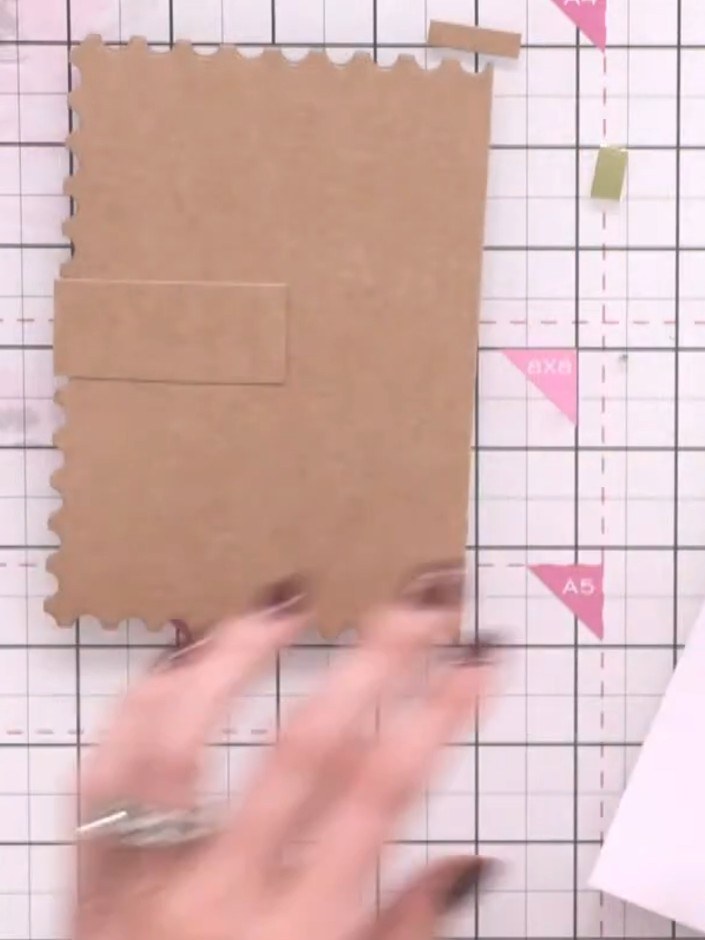 Step 9: Apply adhesive to the back of the card and attach a plain or patterned paper panel to cover the construction a