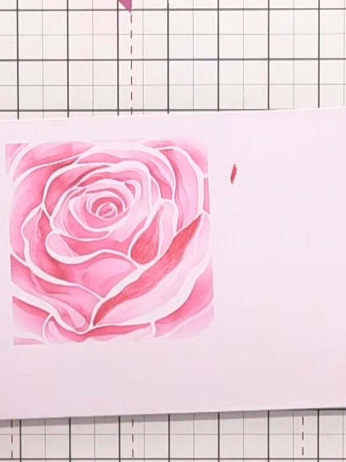 Step 9: Layer your die-cut rose on top of the stencilled and coloured background using foam pads or glue to complete y