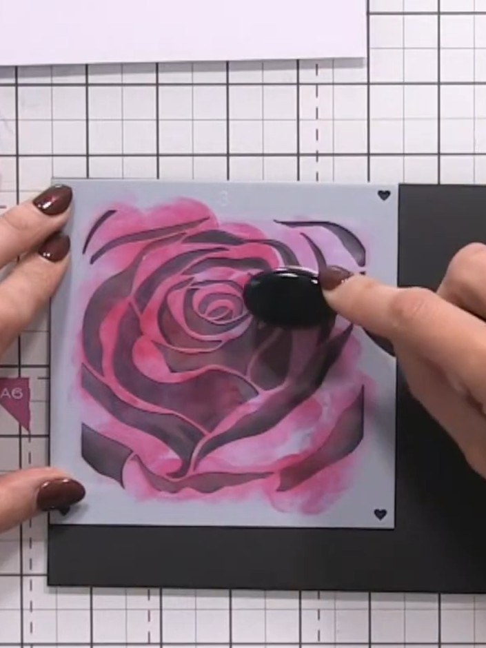 Step 10: Use coloured pencils to add extra detail and shading on top of the layered inks. Work over the rose petals to 