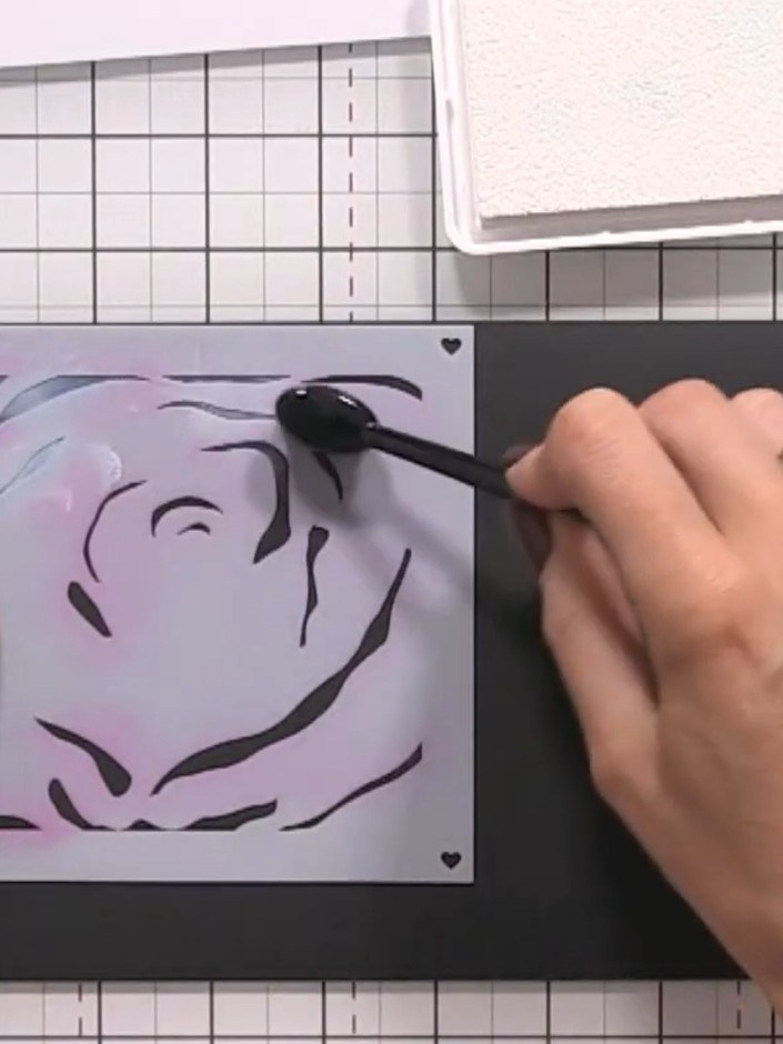 Step 3: Place stencil number three over your card and apply black ink using the ink pad. Vary the pressure as you work
