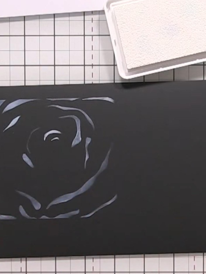 Step 4: Place the fourth and final stencil layer over the black card and apply white ink or paint to complete the ghos