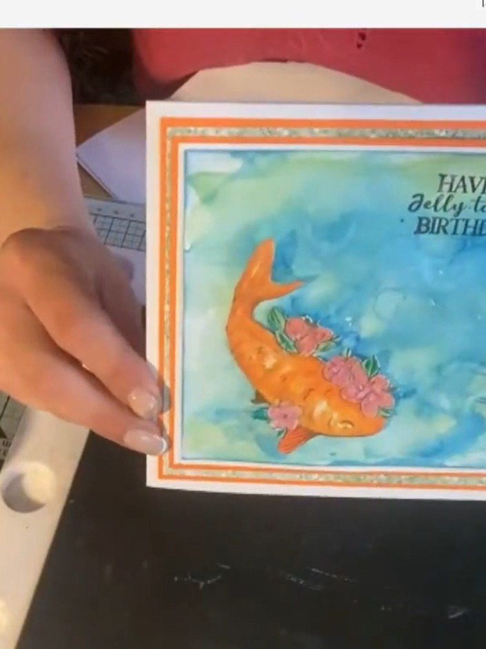 Step 11: Stamp a sentiment such as 'Have a Jellyastic Birthday' in black ink at the top of the card panel.