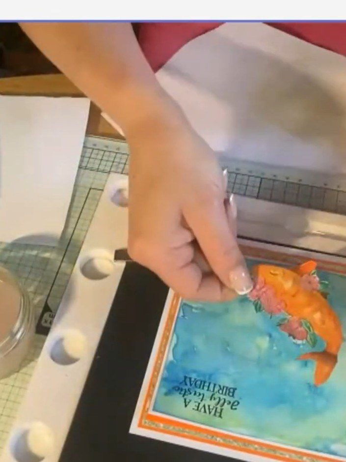 Step 12: Attach the sentiment layer to the front of the card to complete your underwater scene card with the orange fis