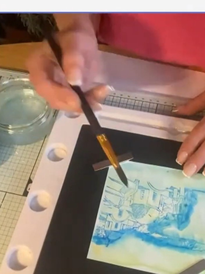 Step 3: Using a small round brush dipped in clean water, gently blend the edges of the stamped image outward to create