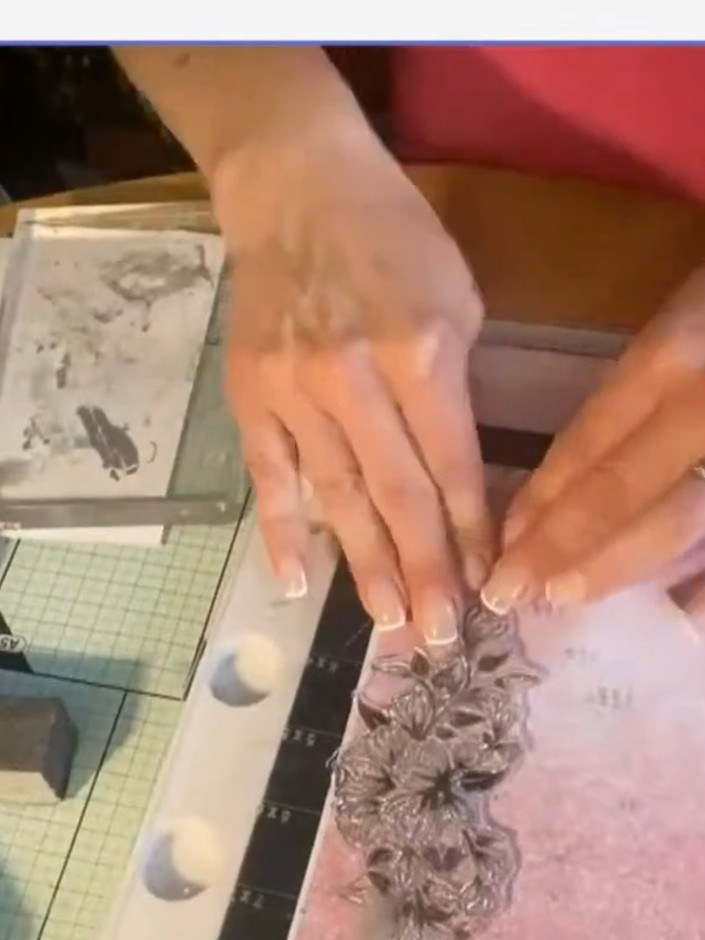 Step 1: Stamp the floral word stamp onto Classic Garden pink patterned paper using distress ink to create a soft, deli