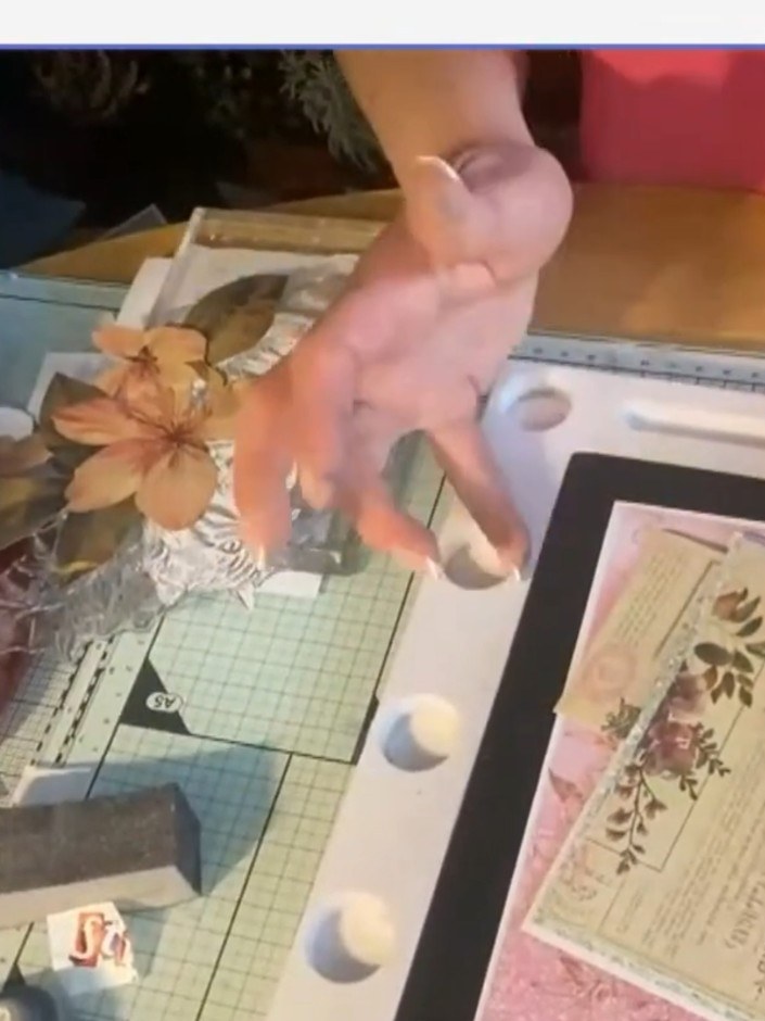 Step 7: Add smaller floral elements and leaves to build up the bloom. Layer the additional pieces around the main flow