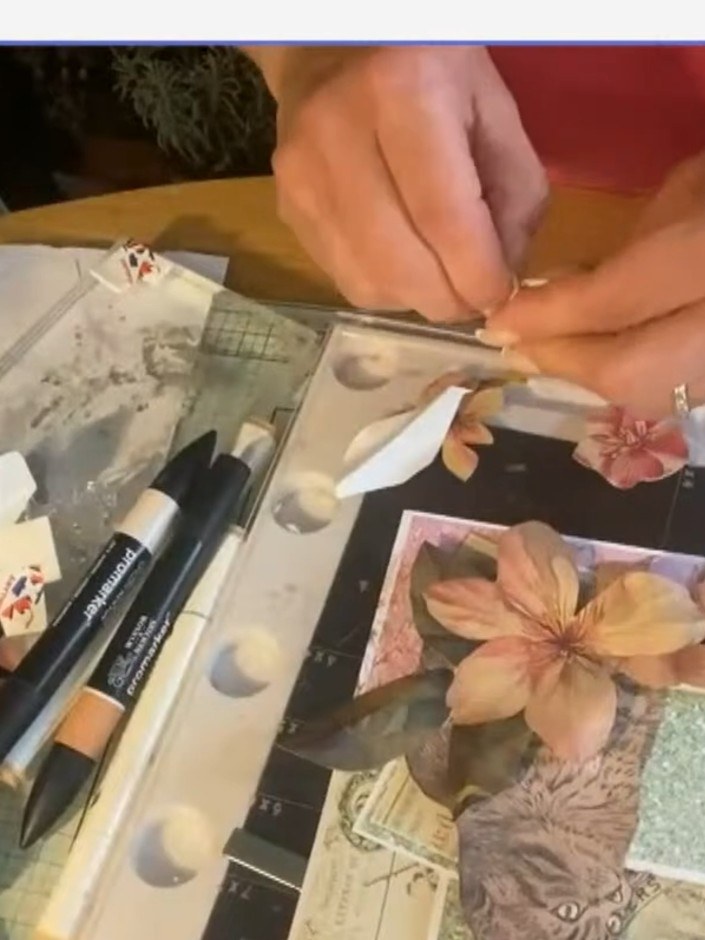 Step 8: Place a circle die cut over the top of your layered project, positioning it to frame the main floral element a