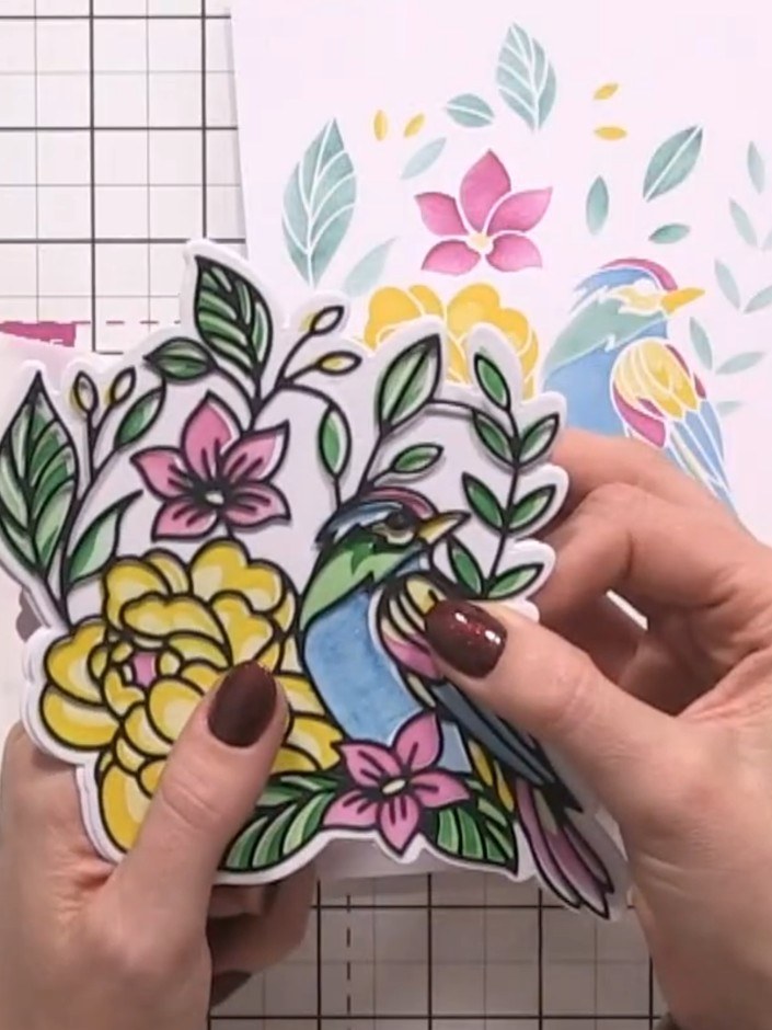 Step 9: Position the completed die-cut bird and floral design on top of your card base to create the finished layered 