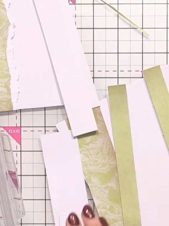 Step 3: Layer additional strips of patterned paper at different heights on your white card base to create a wood panel