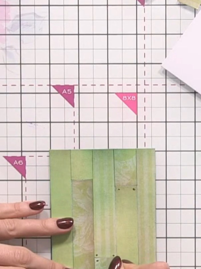 Step 6: Use a gel pen to press indented lines into the green paper strips to create a wood grain texture. Press firmly