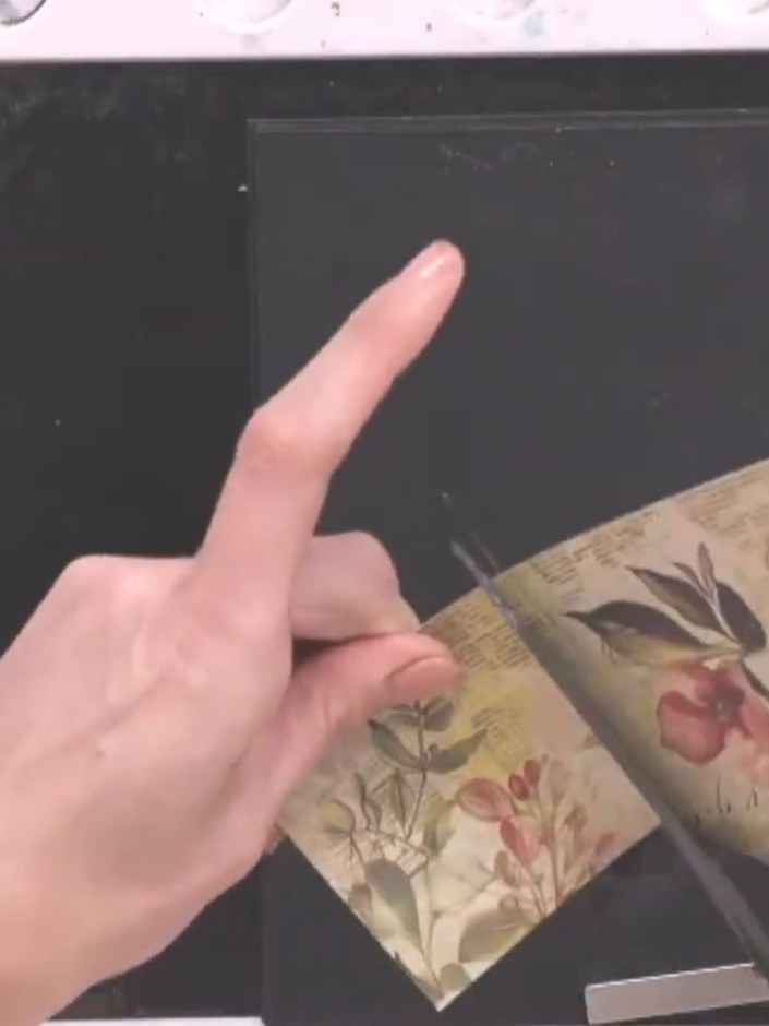 Step 4: Cut a small piece of floral patterned paper for the skirt. Position it on the black card base and stamp the sk