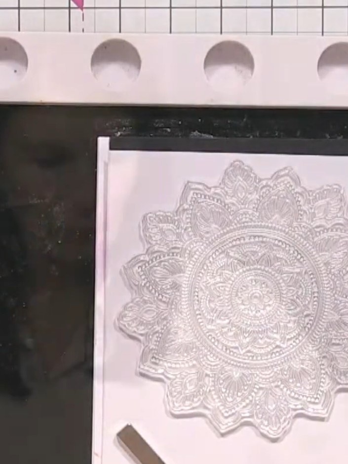 Step 2: Cut the stamped design into four equal squares using a guillotine, cutting down the centre both horizontally a