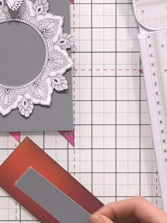 Step 5: Cut a thin panel from the burgundy and grey patterned paper off-cut. Adhere this panel horizontally across the