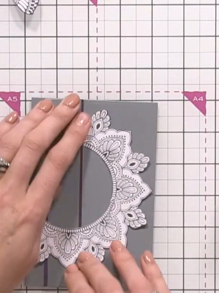 Step 7: Adhere the die-cut embossed panel to the centre front of the grey card base, positioning it so the grey shows 