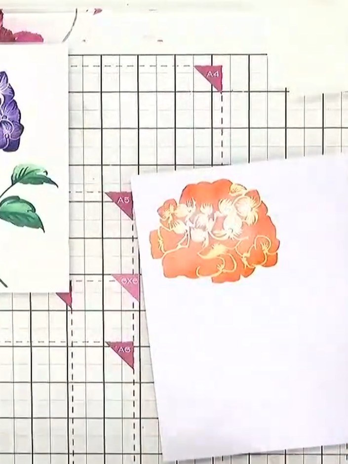 Step 4: Position stencil number three over your card and blend orange ink through the stencil using a blending tool. T