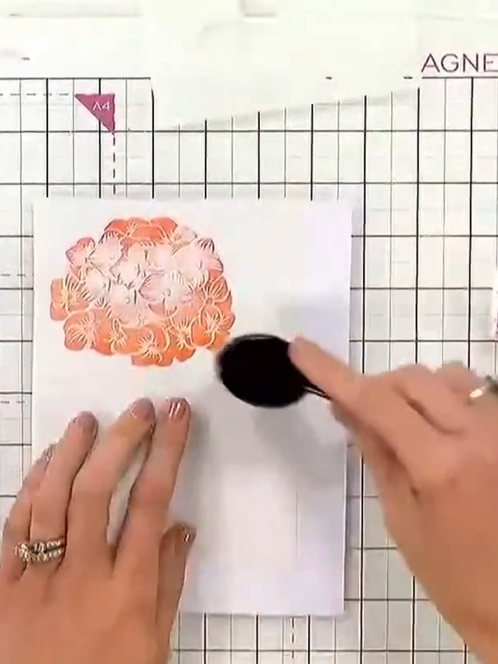 Step 5: Use stencil number four with green ink to add leaf details to the hydrangea. Apply darker tones at the edges f