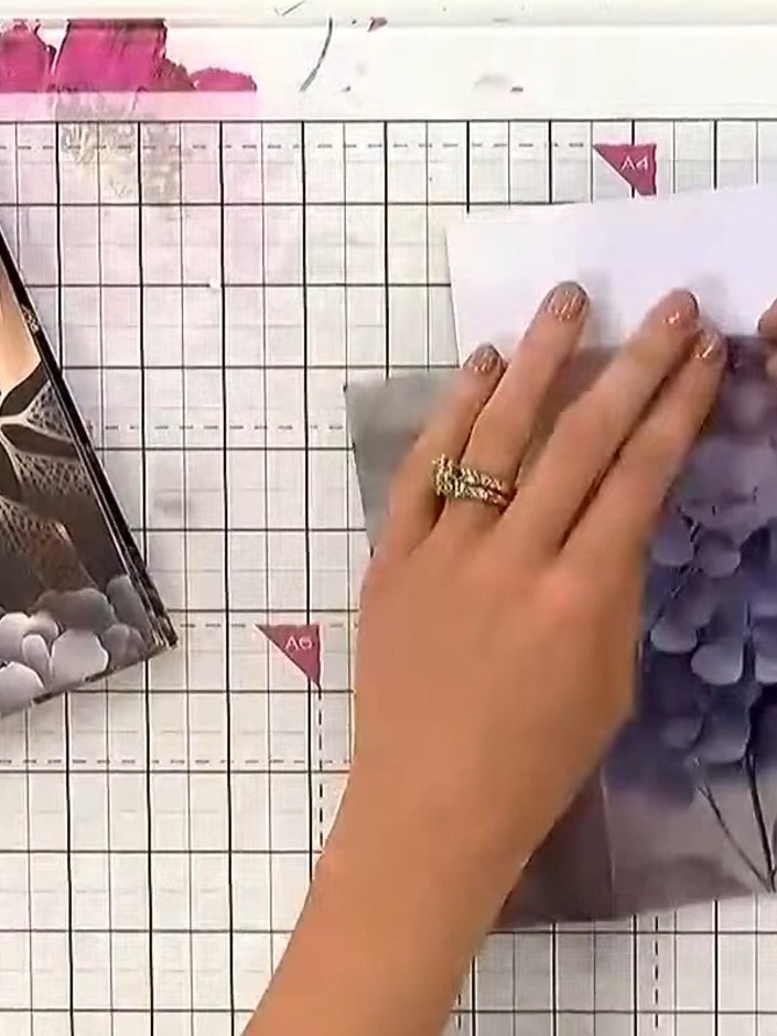 Step 3: Layer additional torn vellum pieces on top of the first layer, positioning them to create visual interest and 