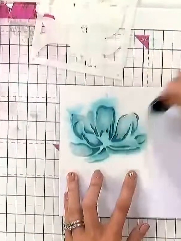 Step 5: Position stencil number five over the magnolia flower and apply pink ink using a blending tool to create a hal