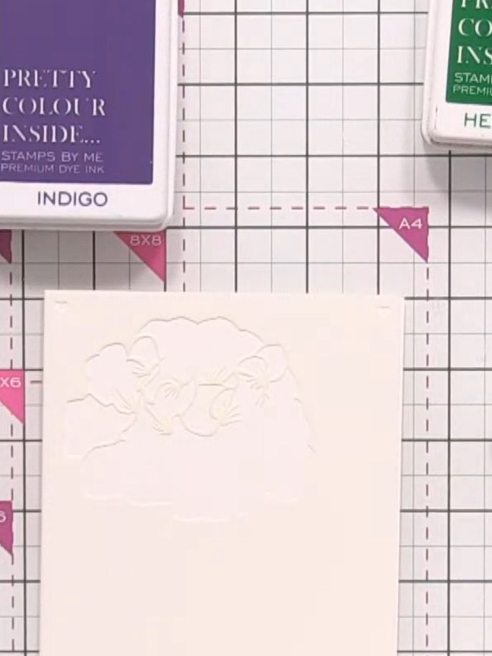 Step 2: Using a blending brush, pick up pink ink and apply it through the first stencil layer on your card. Build up d