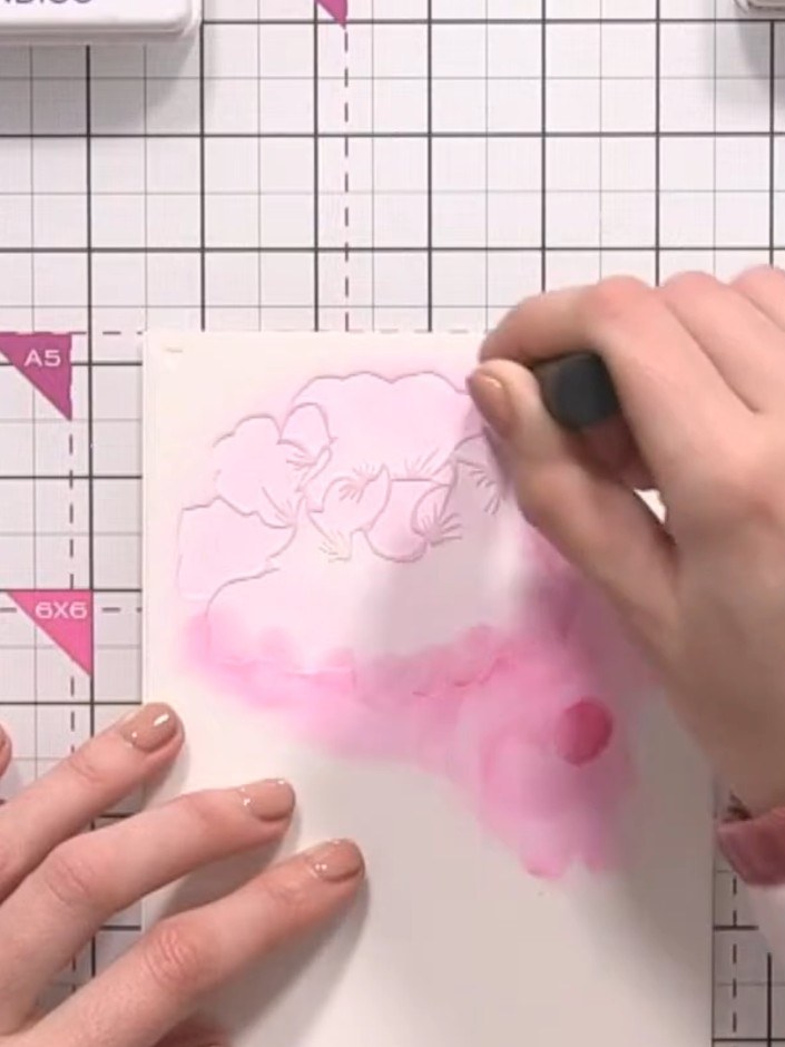 Step 3: Line up stencil number two over your stamped image and apply teal ink through the openings using a blending to